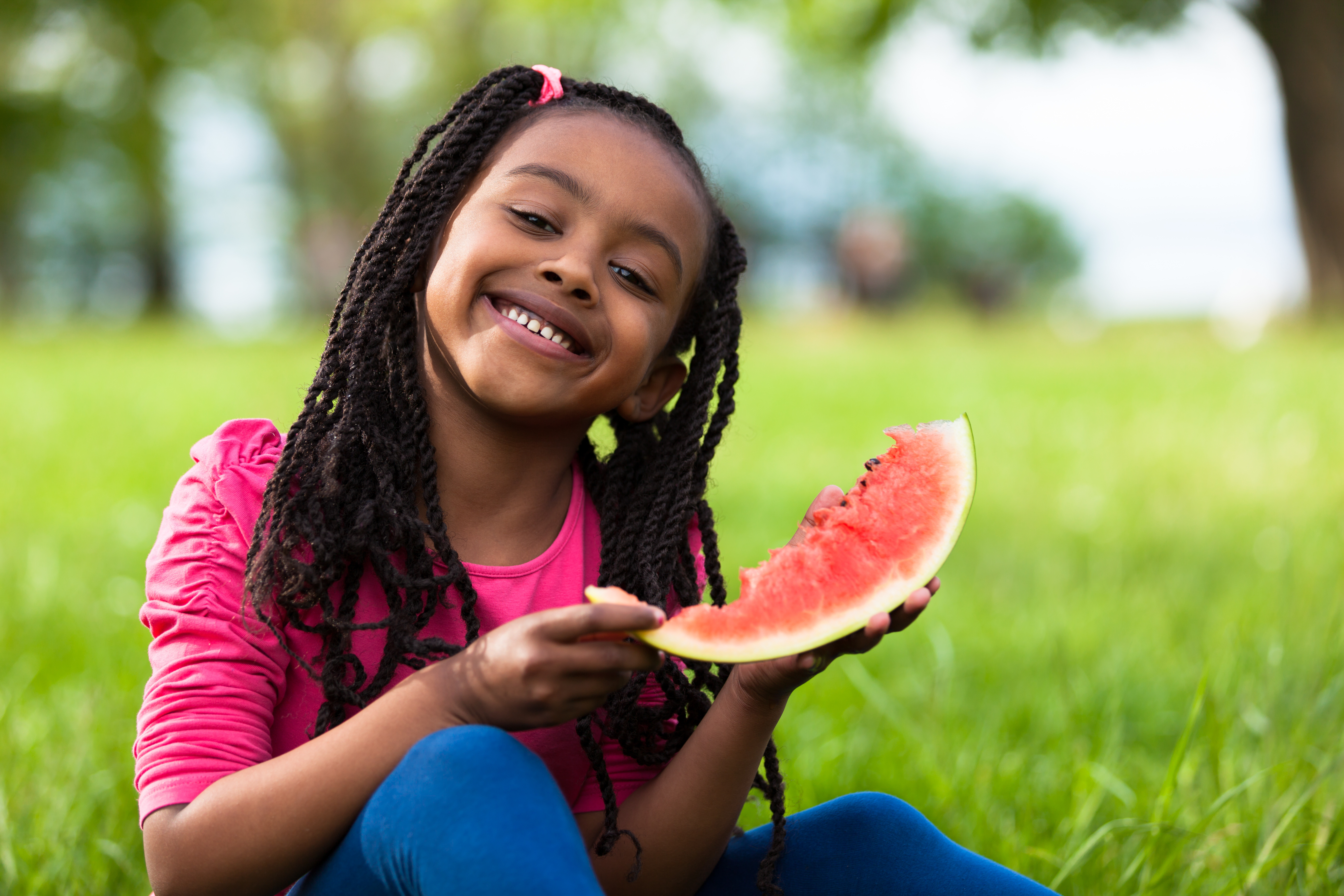 Girl Smiling and Holding Watermelon